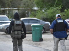 Two U.S. Marshals Task Force Members walking down a road following an arrest