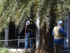 Two U.S. Marshals serving a warrant at a home in Santa Rosa Beach