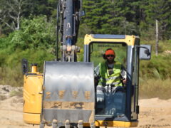 An inmate at the Walton County Jail operates an excavator