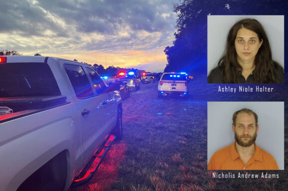 Picture of law enforcement cars and trucks with blue and red lights on the side of the road with the mugshots of a white female with brown hair and a white male with brown hair and brown beard on top
