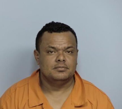 Mug shot of a Hispanic male with a goatee in an orange jumpsuit.