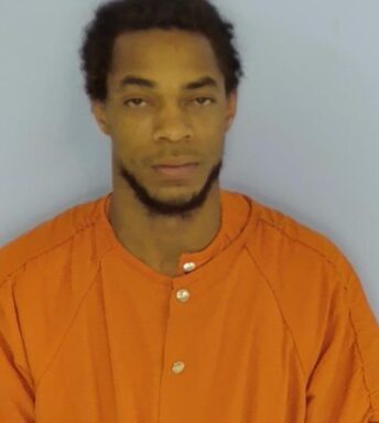 Mug shot of Taurus Washington, black male with dark hair wearing an orange jumpsuit.