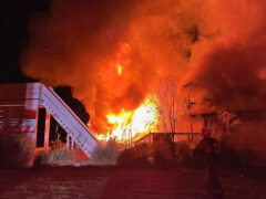 Massive fire at night consuming a home