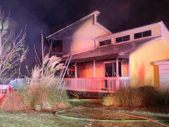 Home at night with heavy damage from house fire