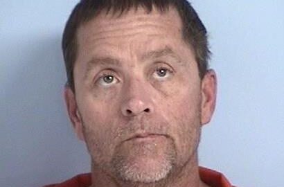 Mug shot of Shaun McBay, white male with brown hair and a brown and graying goatee wearing an orange jumpsuit.