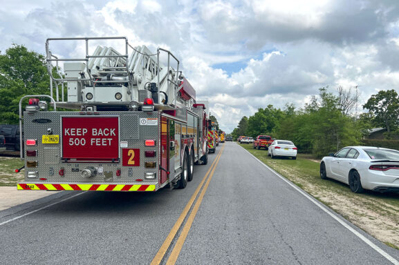 Fire trucks lining up on a two-lane road