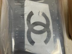 A black duct tape brick of cocaine with the Chanel logo taped to the top