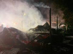 Large pile of metal debris with smoke coming out of it