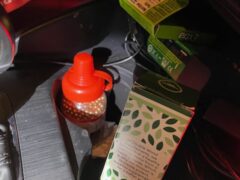 BB gun cartridges placed in the cup holder of a vehicle.