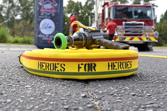 Yellow fire hose with "Heroes For Heroes" on it