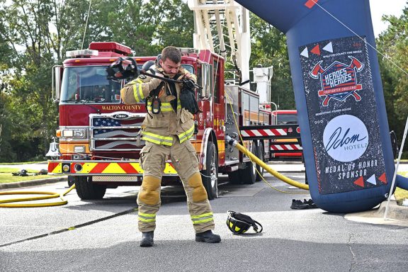 Male firefighter putting on his bunker gear