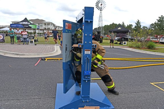 Firefighter breaking through a blue door