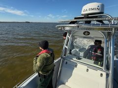 A Deputy looking out at the Choctawhatchee Bay from a boat