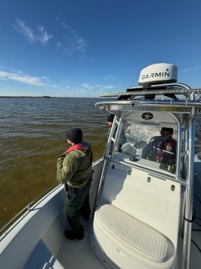 A Deputy looking out at the Choctawhatchee Bay from a boat