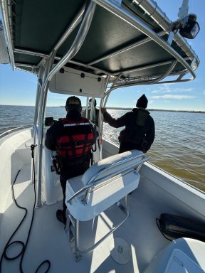 Two deputies looking out on Choctawhatchee Bay from a boat