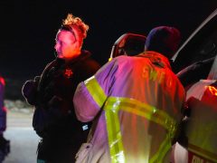 A deputy and firefighter talking in front of a truck