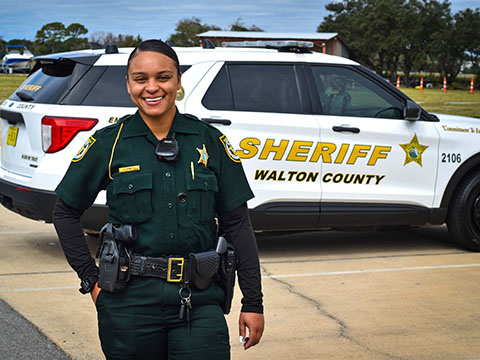 Black female deputy wearing dark green sheriff's deputy uniform