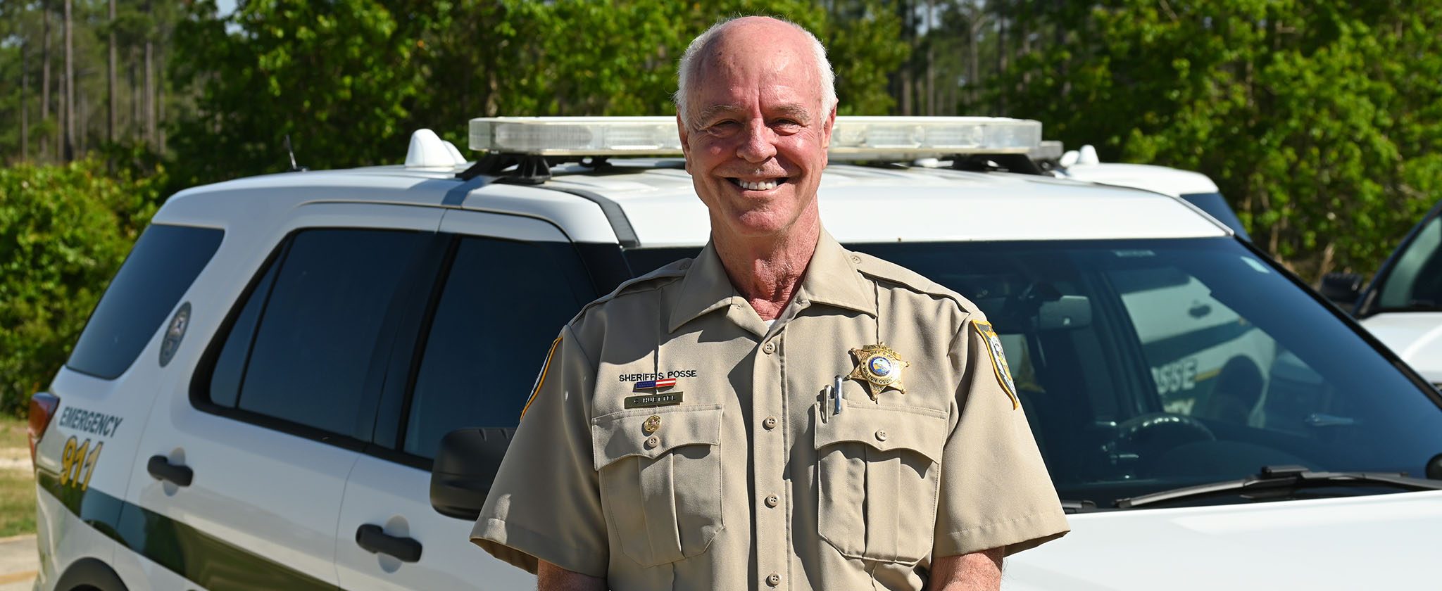 Elderly white male wearing a khaki sheriff's posse uniform