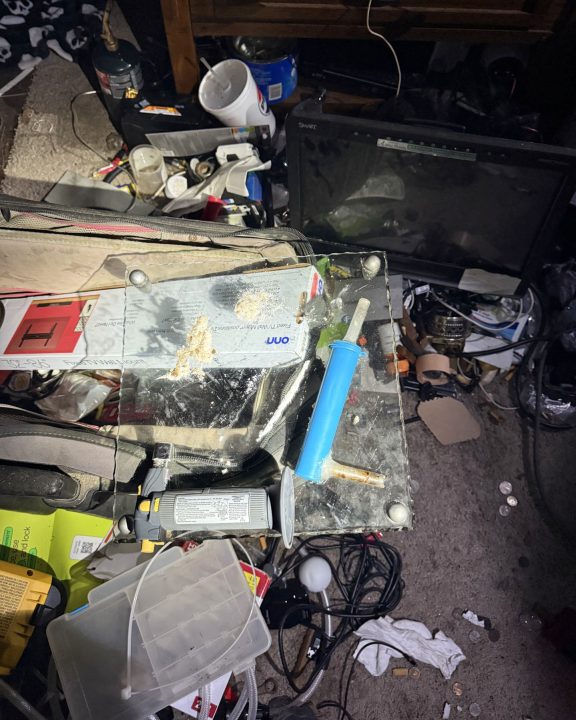 Methamphetamine on a clear scale inside a messy room
