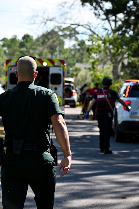 A deputy walks down a street towards an incident