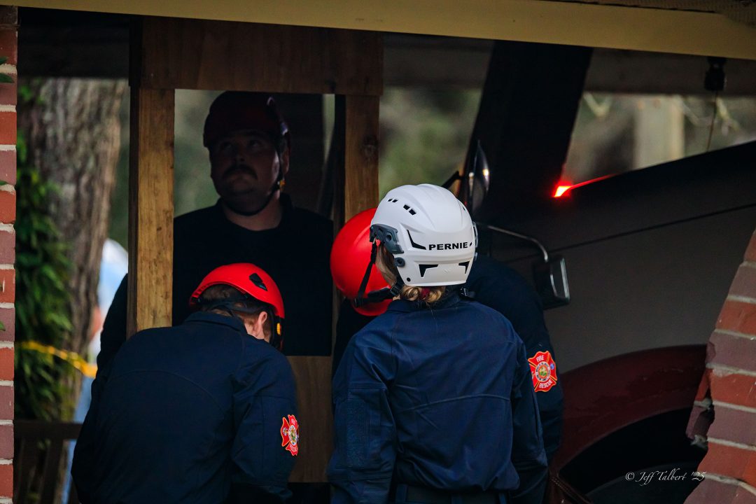 Firefighters installing vertical shores in a damaged home